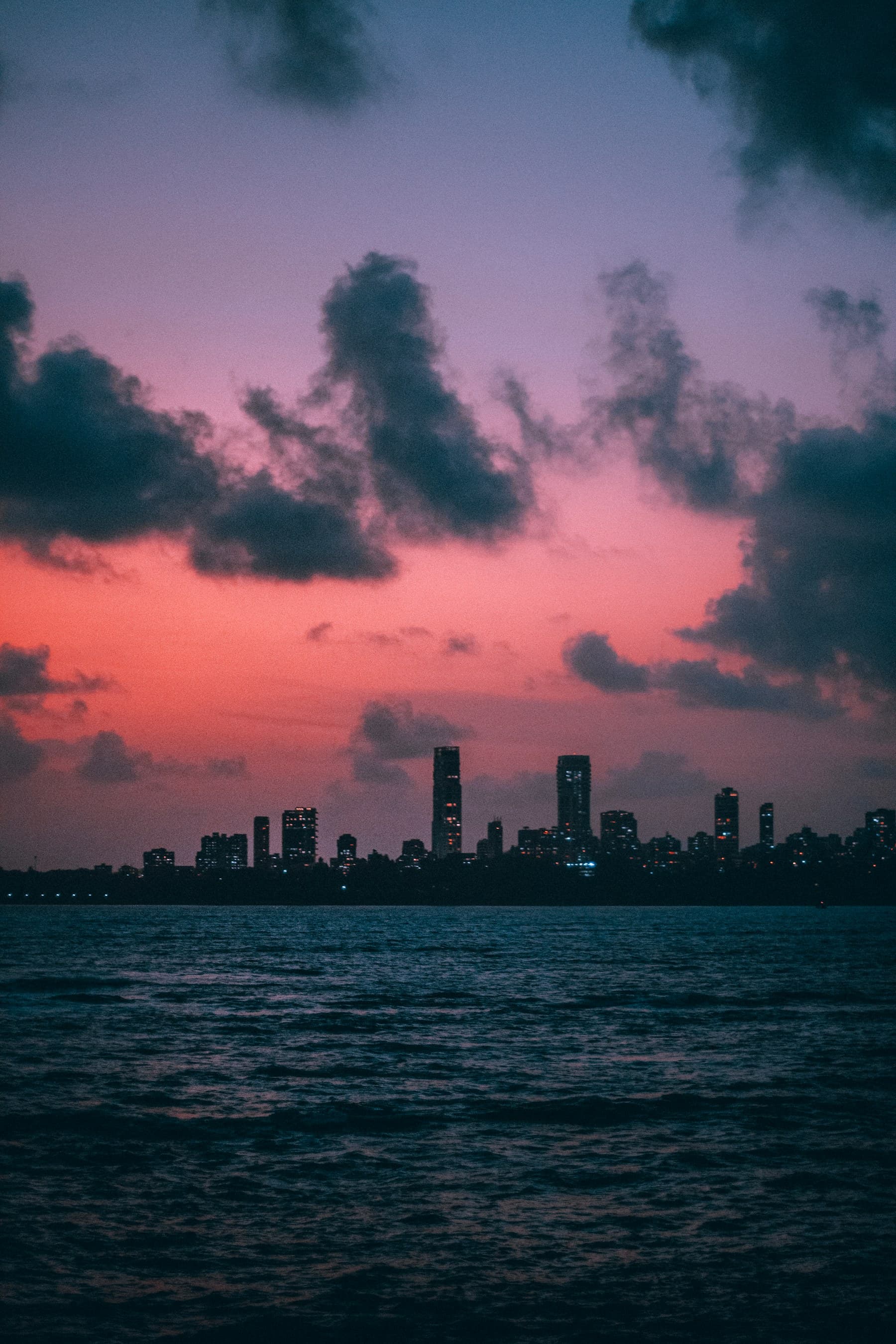 Mumbai skyline across the Arabian Sea at dusk